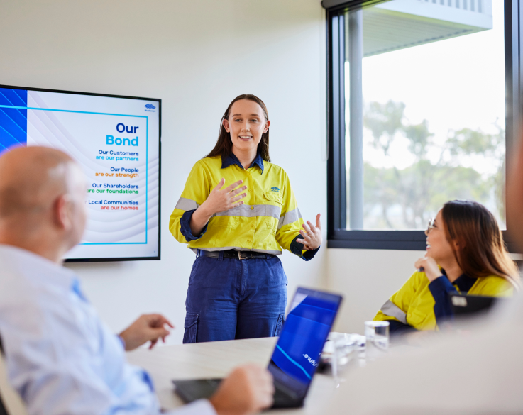 Young BlueScope employee presenting during a board meeting.