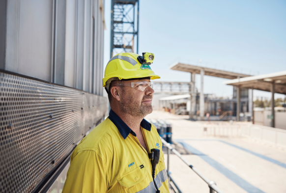 Male BlueScope employee outside facility looking right