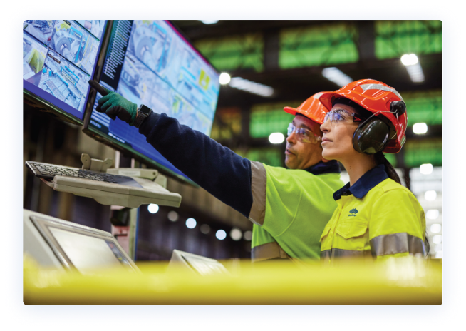 Two BlueScope employees at Manufacturing plant looking at monitors 