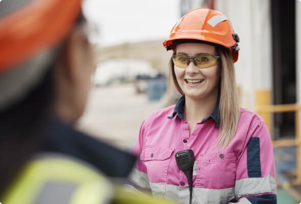 Female BlueScope employee in conversation with colleague outside