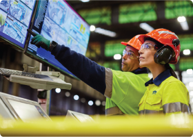 Two Bluescope employees observing  monitors 