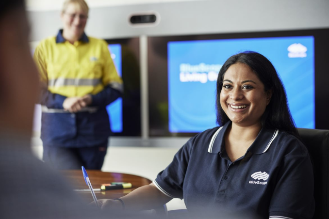 BlueScope employees engaging in conversation in a meeting