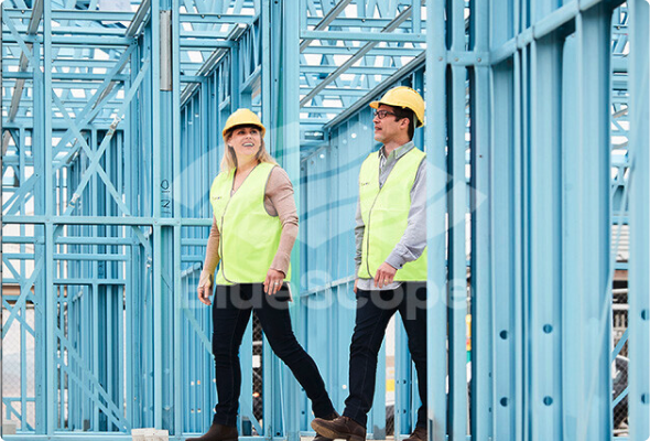 A building frame made from BlueScope's TRUECORE®  with two people carrying out a site inspection