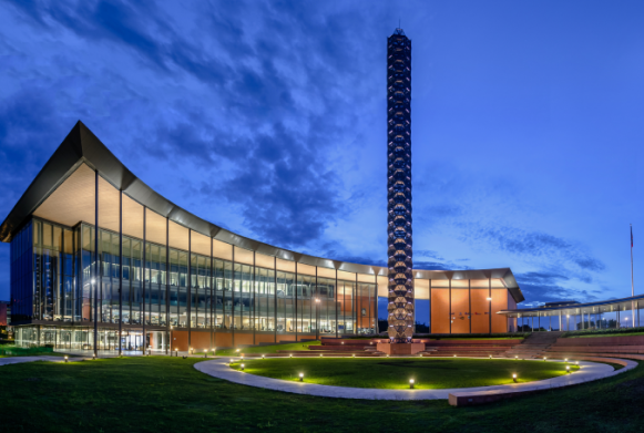 Modernistic circular building at night lit up 