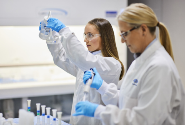 Two BlueScope employees in laboratory measuring liquid