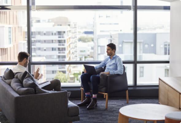 Two BlueScope employees seated comfortably while in discussion