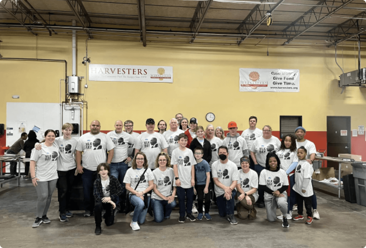 Local community group in matching T-Shirts posing for a photograph 