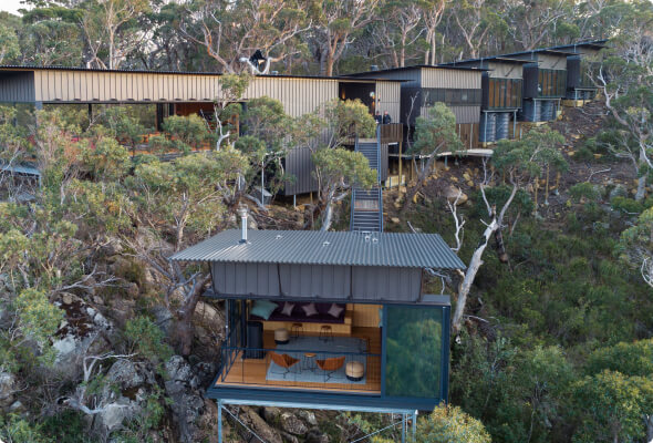 A series of ultra-modern, interconnected homes built on a wooded hillside