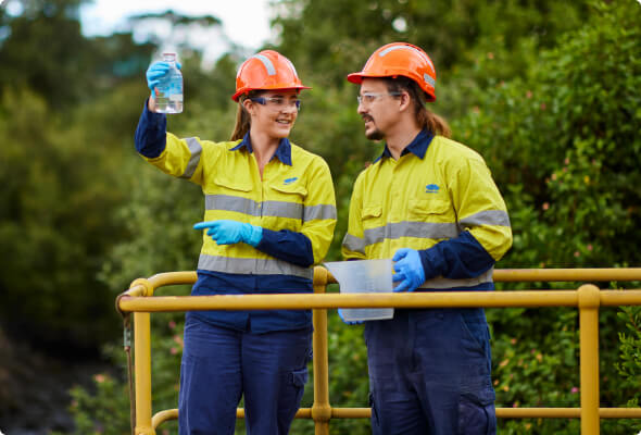 Two BlueScope employees in PPE performing tests on a platform