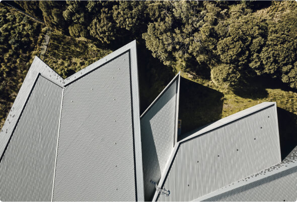 Bird’s-eye view of a large building with a pointed steel corrugated roof