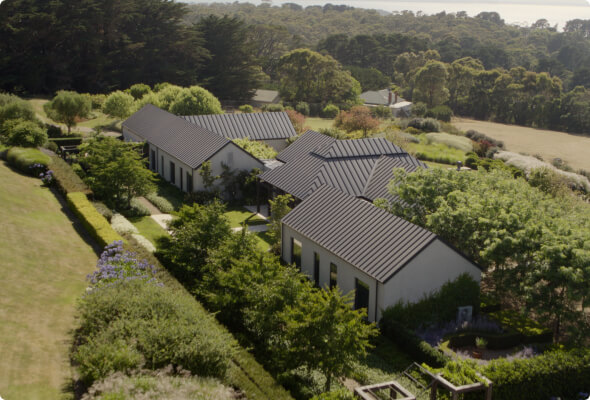 Three one-story buildings tucked away in a green valley