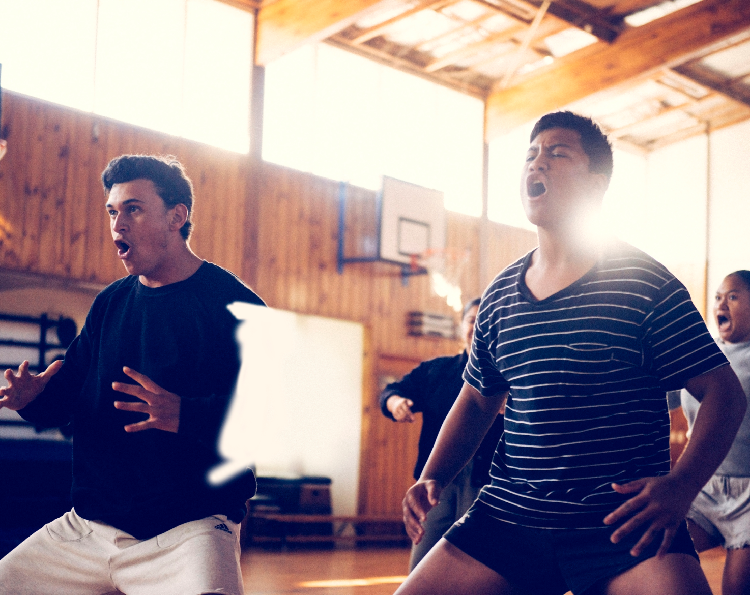 Four locals performing in a timber community center