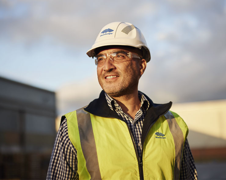 BlueScope employee in an outdoor setting wearing protective gear