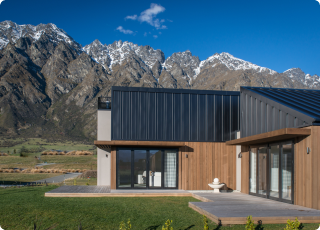 Sustainable home with steel upper cladding set with mountain back drop